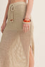 Beige woven skirt with a drawstring waist on a plain background