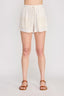 White shorts worn by a person on a white background