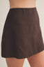 Brown skirt worn by a person on a plain background