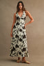 Woman wearing a floral dress against a beige background