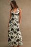 Woman wearing a floral dress against a brown background