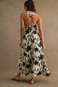 Woman wearing a floral dress with a beige background