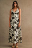 Woman wearing a floral dress against a brown background