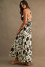 Woman wearing a floral dress against a brown background