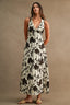 Woman wearing a floral dress against a brown background