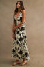 Woman wearing a floral dress against a beige background