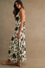 Woman wearing a floral dress against a beige background