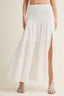 White tiered skirt worn by a person on a plain background