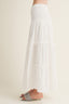 White long skirt worn by a person on a plain background