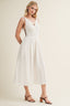 Woman wearing a white dress on a plain background