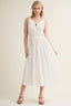 Woman wearing a white dress on a plain background