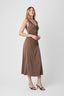 Woman wearing a brown dress on a white background