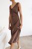 Woman wearing a brown dress with a white background