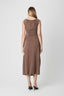 Woman wearing a brown dress on a white background