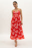 Woman wearing a red floral dress on a white background