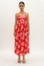 Woman wearing a red floral dress on a white background