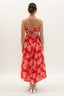 Woman wearing a red floral dress on a white background