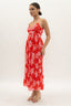 Woman wearing a red floral dress on a white background