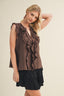Woman wearing a brown ruffled top and black skirt against a beige background