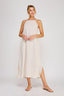 Woman wearing a beige halter neck dress on a white background