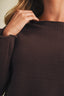 Full-length front view of the Driftwood Bateau Neck Crop Sweater in dark espresso brown styled with beige wide-leg cargo pants, showing the complete cropped silhouette and bateau neckline