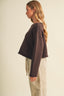Full-length front view of the Driftwood Bateau Neck Crop Sweater in deep chocolate brown paired with stone beige cargo pants and tan loafers, showcasing the complete coastal-boho outfit and the sweater's boxy cropped proportions
