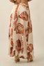 Long skirt with butterfly pattern worn by a person on a plain background