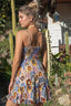 Woman wearing a colorful patterned dress in a garden setting
