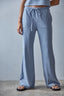 Person wearing blue striped pants against a gray background