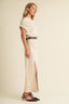 Side profile view of the Soleil Cowl Neck Belted Maxi Dress in cream, highlighting the sleek longline column form, side-waist gathering, removable belt, and high side slit detail at the hem