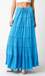 Blue tiered maxi skirt worn by a person on a white background