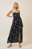 Woman wearing a strapless floral dress on a beige background