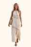 Woman in a coastal beige halter cut out maxi dress
