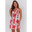 Woman wearing a red floral dress on a white background