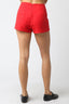 Red shorts worn by a person on a white background