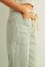 Light blue and white striped pants with a neutral background
