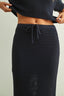 Navy blue textured skirt worn by a person on a light gray background