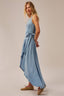 Woman wearing a light blue dress on a beige background