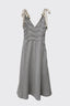 Striped dress with tie straps on a light gray background