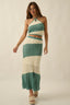 Woman wearing a green and white striped dress on a beige background