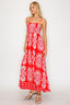 Woman wearing a red floral dress on a white background