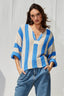 Woman wearing a blue and white striped sweater against a light gray background