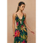 Woman wearing a colorful floral dress against a beige background
