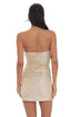 Woman wearing a strapless gold dress on a white background