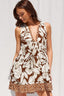 Woman wearing a brown floral dress against a white background