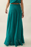 Teal maxi skirt worn by a person on a plain background