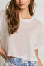 Woman wearing a white textured top with a plain background