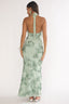 Woman wearing a green floral dress with a white background