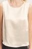 Beige sleeveless top worn by a person on a plain background
