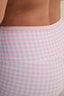 Close-up of pink gingham shorts with a checkered pattern.
